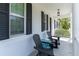 Cozy front porch featuring rocking chairs, stylish entrance door, and architectural details, perfect for enjoying the outdoors at 14563 Bahama Swallow Blvd, Winter Garden, FL 34787