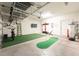 Spacious garage featuring overhead storage, a water heater and a putting green at 14563 Bahama Swallow Blvd, Winter Garden, FL 34787