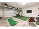 Spacious garage featuring overhead storage, a putting green, and a TV at 14563 Bahama Swallow Blvd, Winter Garden, FL 34787