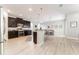 Bright open concept kitchen featuring dark wood cabinets, stainless appliances, and breakfast bar with pendant lighting at 14563 Bahama Swallow Blvd, Winter Garden, FL 34787