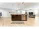 A large kitchen island features a stainless steel dishwasher, dark wood cabinets, and bar seating at 14563 Bahama Swallow Blvd, Winter Garden, FL 34787