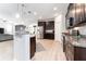 A contemporary kitchen boasts granite countertops, stainless steel appliances, and dark wood cabinetry at 14563 Bahama Swallow Blvd, Winter Garden, FL 34787