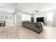 Bright living room with light wood floors, large window, and gray sofa at 14563 Bahama Swallow Blvd, Winter Garden, FL 34787