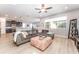 Open living area features a gray sectional sofa, light wood floors, and access to the kitchen and dining areas at 14563 Bahama Swallow Blvd, Winter Garden, FL 34787