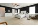 Main bedroom with black accent wall, white trim, and comfortable furnishings at 14563 Bahama Swallow Blvd, Winter Garden, FL 34787