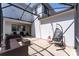 The screened patio includes a seating area, egg chair, and string lights providing a cozy outdoor space at 14563 Bahama Swallow Blvd, Winter Garden, FL 34787
