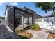Exterior of home showcasing screened-in patio with lounge furniture and yard at 14563 Bahama Swallow Blvd, Winter Garden, FL 34787