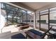 Screened-in patio featuring a cozy seating area with outdoor furniture and a hanging chair at 14563 Bahama Swallow Blvd, Winter Garden, FL 34787
