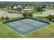 Aerial view of well-maintained tennis court with community pool and surrounding wetlands at 14563 Bahama Swallow Blvd, Winter Garden, FL 34787
