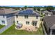 Two-story home featuring a patio with a hot tub and solar panels on the roof at 159 Lazy Willow Dr, Davenport, FL 33897
