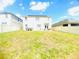 Spacious backyard enclosed by white vinyl fencing, with a hot tub, patio and green space at 159 Lazy Willow Dr, Davenport, FL 33897