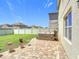 Backyard features a green lawn and a brick patio with a hot tub and a view of the neighborhood at 159 Lazy Willow Dr, Davenport, FL 33897