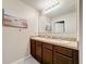 Bathroom featuring granite countertops, and sinks, and a large mirror above the vanity at 159 Lazy Willow Dr, Davenport, FL 33897