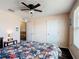 Bedroom featuring a ceiling fan and a bed with floral print comforter at 159 Lazy Willow Dr, Davenport, FL 33897