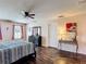 Bedroom with stylish decor, wooden floors, dresser, and lots of natural light at 159 Lazy Willow Dr, Davenport, FL 33897