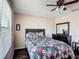 Bedroom featuring dark wooden floors and a floral comforter with matching pillow shams at 159 Lazy Willow Dr, Davenport, FL 33897