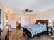 Well-lit primary bedroom featuring dark wood floors, a ceiling fan and lots of windows at 159 Lazy Willow Dr, Davenport, FL 33897