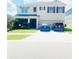 Two-story home featuring a two-car garage, well-maintained lawn and driveway with two parked cars at 159 Lazy Willow Dr, Davenport, FL 33897