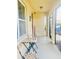Inviting front porch featuring neutral paint, a seating area, welcome decor and an outdoor security camera at 159 Lazy Willow Dr, Davenport, FL 33897