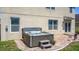 Backyard with a hot tub and brick patio perfect for relaxing and entertaining at 159 Lazy Willow Dr, Davenport, FL 33897