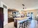 Open kitchen with a large center island, bar seating, and dark cabinetry for a modern feel at 159 Lazy Willow Dr, Davenport, FL 33897