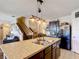 Open concept kitchen with a large island with drop lighting, stainless steel sink, and seating at 159 Lazy Willow Dr, Davenport, FL 33897