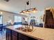 Spacious kitchen featuring a center island with a sink, open to the living area and staircase at 159 Lazy Willow Dr, Davenport, FL 33897