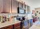 Well-equipped kitchen featuring stainless steel appliances, granite countertops, and ample cabinet space at 159 Lazy Willow Dr, Davenport, FL 33897