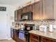Traditional-style kitchen featuring stainless steel appliances and attractive backsplash and neutral countertops at 159 Lazy Willow Dr, Davenport, FL 33897