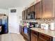 Well-equipped kitchen with dark cabinetry, tile backsplash, and modern appliances for culinary enthusiasts at 159 Lazy Willow Dr, Davenport, FL 33897