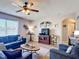 Comfortable living room featuring matching sofas, ceiling fan, hardwood floors, and plenty of natural light at 159 Lazy Willow Dr, Davenport, FL 33897