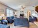 Comfortable living room featuring matching sofas, ceiling fan, hardwood floors, and plenty of natural light at 159 Lazy Willow Dr, Davenport, FL 33897