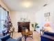 Cozy living room features a decorative fireplace, comfortable seating, and plenty of natural light at 159 Lazy Willow Dr, Davenport, FL 33897