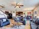 Open-concept living room with stylish decor, comfortable seating, and seamless flow to the kitchen and dining area at 159 Lazy Willow Dr, Davenport, FL 33897