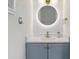 Modern bathroom featuring a vanity with a round mirror, updated fixtures, and a sleek design at 2013 Pineway Dr, Orlando, FL 32839