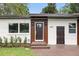 Charming home featuring a decorative front door, well-maintained landscaping, and modern architectural details at 2013 Pineway Dr, Orlando, FL 32839