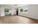 Bright living room with hardwood floors, a large window overlooking the front yard, and an open doorway at 2013 Pineway Dr, Orlando, FL 32839