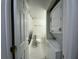 Bathroom with laundry machine, black-and-white tiled floor, and a shower behind the door at 568 Bahia Cir # B, Ocala, FL 34472