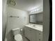 Bathroom with vanity and white cabinets, black-and-white tiled floor, and a mirror at 568 Bahia Cir # B, Ocala, FL 34472