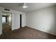 Bedroom with brown carpet, a ceiling fan and a closet at 568 Bahia Cir # B, Ocala, FL 34472