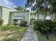 A charming, two-story condo building with a beautifully landscaped yard and an inviting walkway entrance at 568 Bahia Cir # B, Ocala, FL 34472