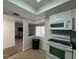 A kitchen featuring white appliances and a view of the living room at 568 Bahia Cir # B, Ocala, FL 34472