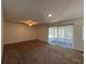 A bright living room with carpeted floors and a ceiling fan at 568 Bahia Cir # B, Ocala, FL 34472