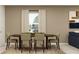 Comfortable dining room with seating for six around a dark wood table and neutral wall color at 7558 Headwaters Ct, Groveland, FL 34736