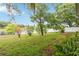 Landscaped backyard overlooking a serene lake, featuring well-maintained grass and diverse foliage at 13219 Meadowlark Ln, Orlando, FL 32828