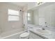 Bright bathroom with a large mirror, tub, and updated vanity at 13219 Meadowlark Ln, Orlando, FL 32828