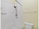 Bathroom with white tile shower featuring a mounted shower head and grab bar at 13219 Meadowlark Ln, Orlando, FL 32828
