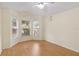 Bright bedroom featuring three windows, wood flooring, and a charming Parisian decorative theme at 13219 Meadowlark Ln, Orlando, FL 32828