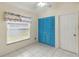 Bedroom featuring tile flooring, neutral walls, ceiling fan, and blue closet doors at 13219 Meadowlark Ln, Orlando, FL 32828