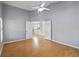 Bright bedroom boasts an open layout with wood floors and a ceiling fan for enhanced comfort at 13219 Meadowlark Ln, Orlando, FL 32828